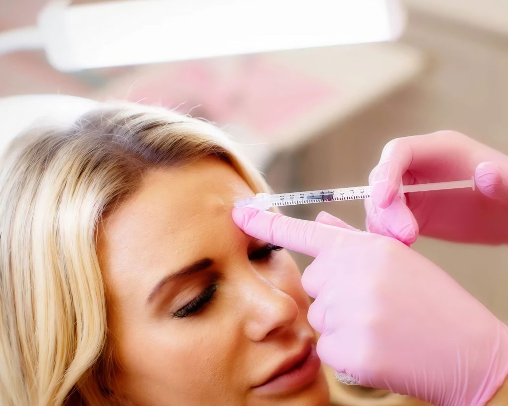 Neuromodulator Injection Receiving In The Forehead